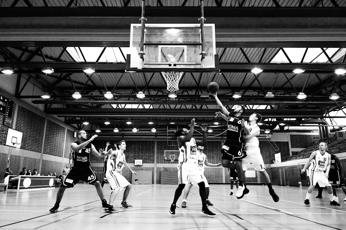 Basketball players going up for a layup in a gymnasium